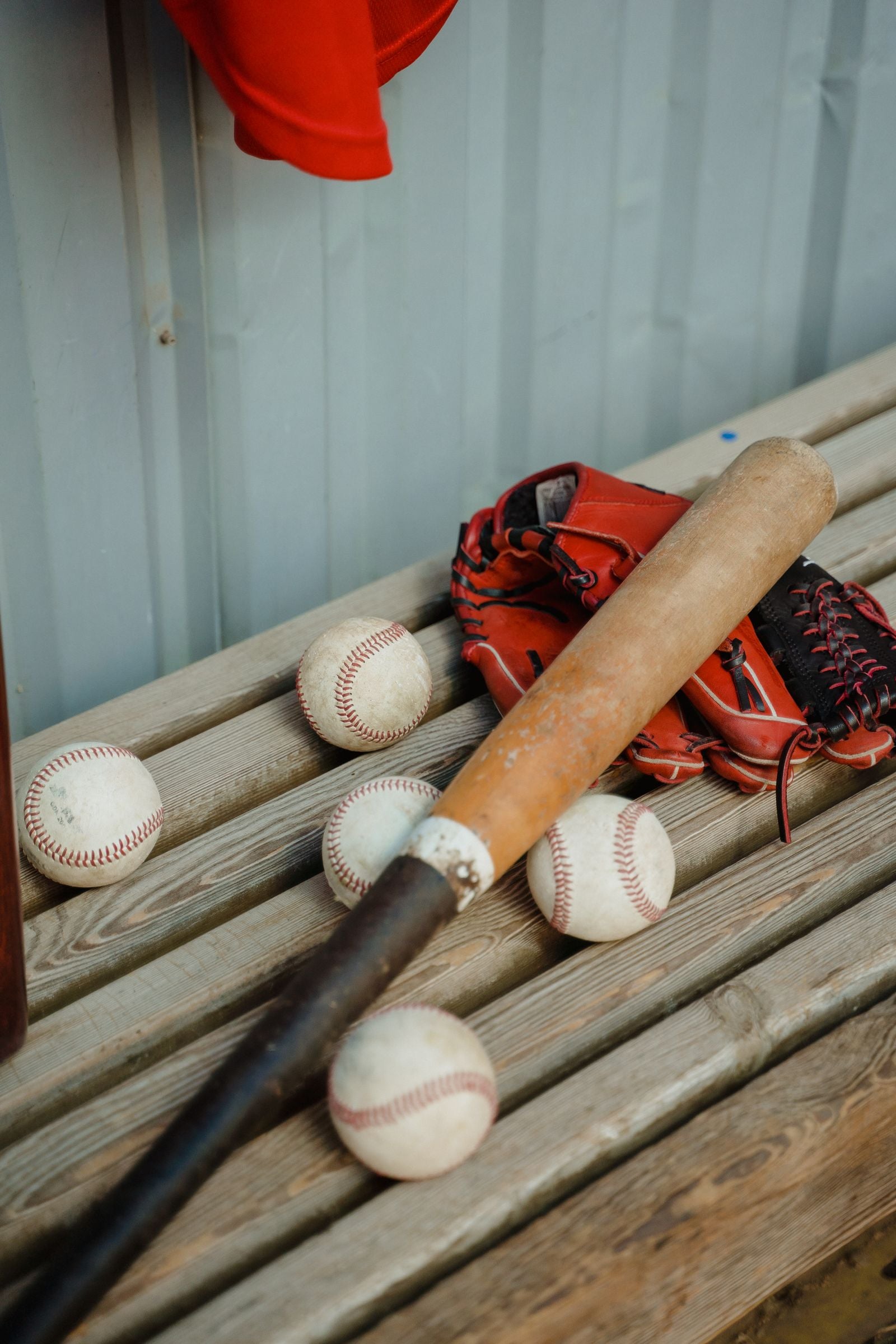 Baseball equipment arranged on a dugout bench