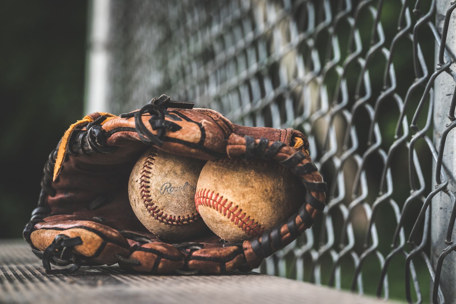 Baseball glove beside a collector's sports cards